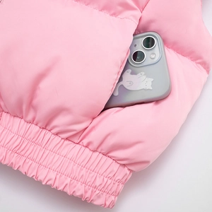 Detail of pink quilted puffer vest featuring elastic hem and side pocket with smartphone