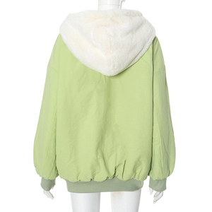 Detail view of the reversible light green hooded jacket with soft white plush lining