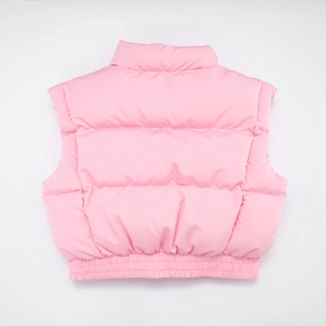 Detail of pink quilted puffer vest featuring high collar and elastic hem stitching