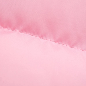 Macro view showing high-quality stitching and pink synthetic fiber texture of the vest