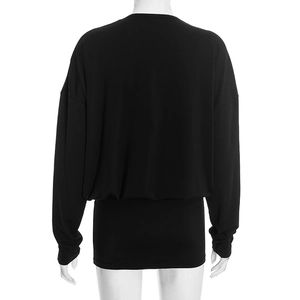 Detail view of the black long sleeve batwing dress showing the elastic waist and knit fabric