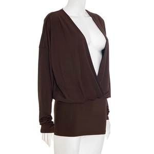 Detail of cross-draped deep V-neck and batwing sleeve on dark coffee knit mini dress