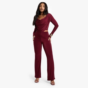 Detail of burgundy two-piece set featuring a cowl neck long sleeve top and wide leg pants