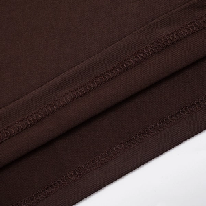 Detail of dark brown knitted dress featuring ribbed texture and double-needle stitching