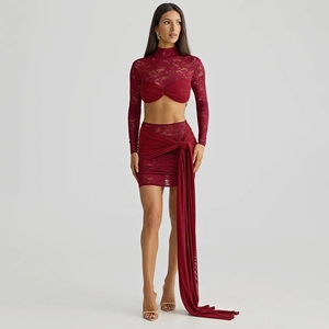 Detail view of burgundy lace crop top with ruffle tie-knot and matching mini skirt