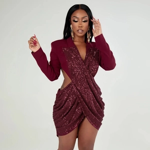 Detail of burgundy sequin blazer dress with side waist cut-out and draped skirt detail