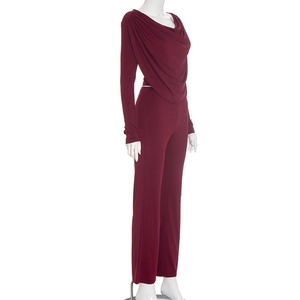 Detail of burgundy two-piece set featuring draped neck top and matching wide leg pants