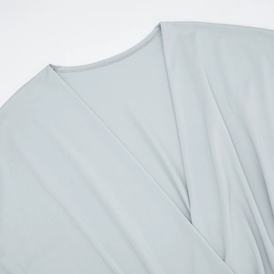 Detailed view of grey V-neck dress stitching and high-quality fine fabric texture