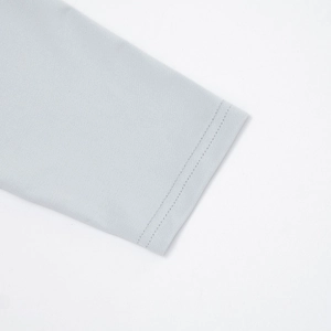 Close-up of light blue knitted dress hem featuring high-quality double-stitched sewing