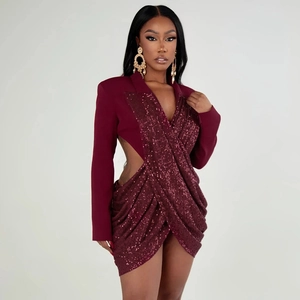 Detail of burgundy sequin blazer dress featuring waist cut-out and glossy finish