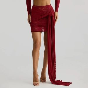 Detailed macro view of the wine red lace mini skirt with elegant side tie ribbon detail