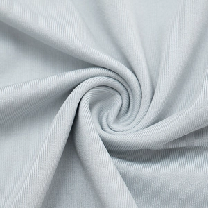 Macro shot of light gray fine knit fabric texture with soft ribbed weave and elegant drape