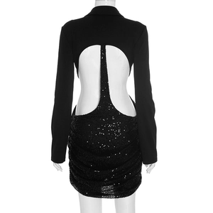 Detail of elegant backless dress with sequins and long sleeves on a white mannequin