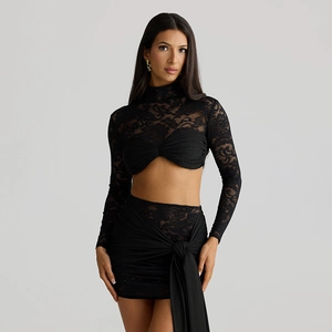 Close-up of black lace fabric textures and knotted streamers on a two-piece set