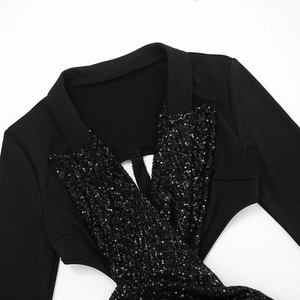 Detailed view of black sequined V-neckline and cutout design on long sleeve dress