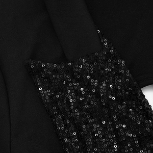 Macro shot of shimmering black sequins sewn on elegant fabric showing light reflections