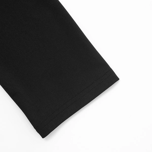 Close-up of double-stitched hem and soft black knit texture on long sleeve sequin dress