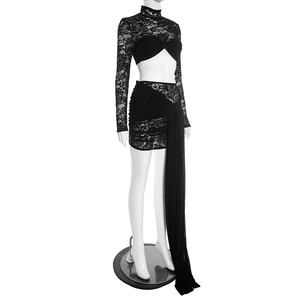 Detail view of black lace crop top with ruched bust and mini skirt with long side ribbons