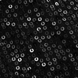 Close-up of high-density black sequins stitched on mesh for an elegant evening dress