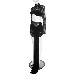 Detail of black lace two-piece set featuring long-sleeved crop top and skirt with long drapes