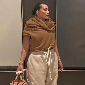 Close-up of caramel cropped hoodie drawstring detail and contrast beige high waist pants