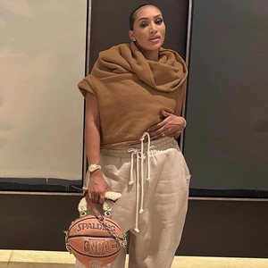 Detail of basketball shaped handbag with gold chain strap and plush fleece top handle