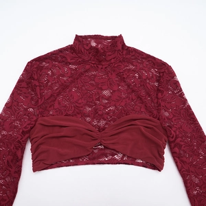 Detail of burgundy lace crop top featuring mesh twist knot design and floral patterns