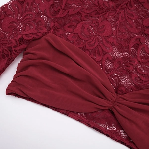 Detail of burgundy lace floral patterns and ruched mesh texture on this two-piece set