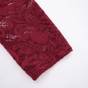 Detail shot of dark red floral lace fabric with intricate hollowed-out crochet texture