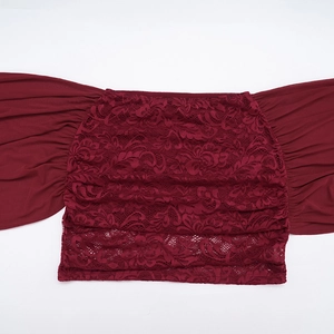 Detail of burgundy lace off-the-shoulder top with floral patterns and pleated sleeves