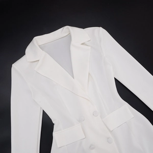 Flat lay macro of a slim fit white blazer dress with double-breasted buttons and flap pockets