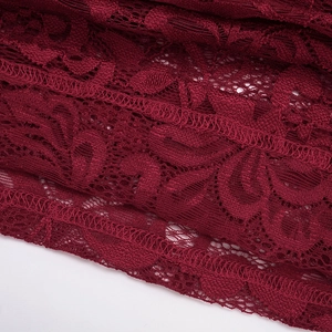 Close-up of wine red lace fabric with intricate floral hollow-out patterns and fine stitching