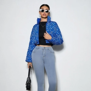 Detail of navy paisley print on reversible quilted jacket with premium zipper and high collar