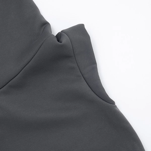 Close-up detail of dark grey knitted hoodie showing fine fabric texture and stitching line