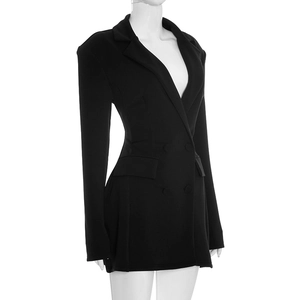 Detail of a slim fit black double-breasted blazer dress with lapels and flap pockets