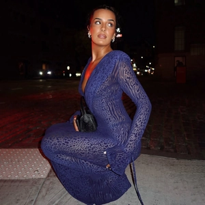 Macro detail of navy blue velvet flocking leopard print on sheer mesh V-neck dress