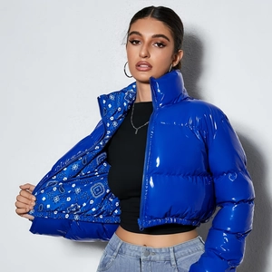 Detail of blue glossy puffer jacket featuring an elegant paisley printed inner lining