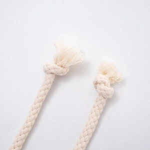 Detailed close-up of thick woven cotton drawstring with knotted ends and fringe details