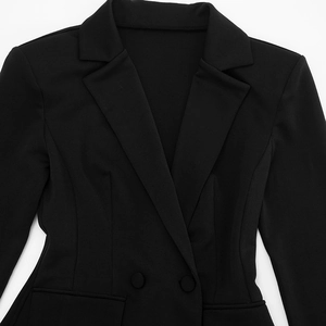 Close-up of lapel and double-breasted buttons on a slim black blazer dress