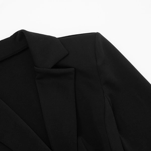 Detail of black blazer dress neckline and shoulder seam with premium fabric texture