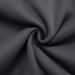 Macro detail of dark grey knitted fabric showing soft texture and premium flexible fibers