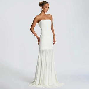 Detail of the elegant white strapless evening dress with pleated chiffon mesh hemline