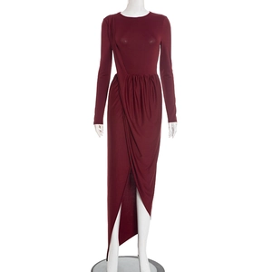 Detail of burgundy long sleeve dress featuring elegant side pleats and asymmetric slit hemline