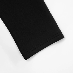 Detail shot of the black knit dress sleeve with precise double-needle flat stitching