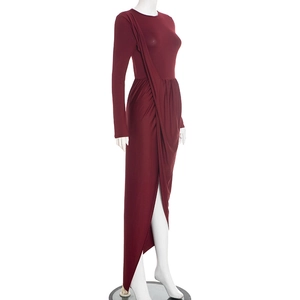 Detail of burgundy slim fit dress showing asymmetric layered hem and elegant pleats