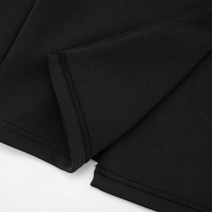 Detailed view of the fine stitching and smooth knitted fabric on a slim black blazer dress