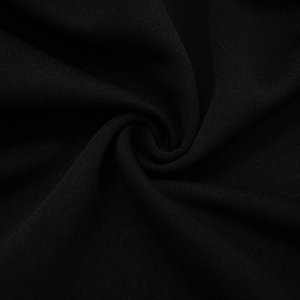 Close-up detail of premium black knitted fabric showing fine texture and soft drape