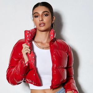 Detail of red glossy puffer jacket collar featuring red and white bandana print lining