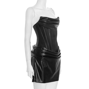 Detail of black PU leather tube dress featuring corset boning and pleated fabric texture