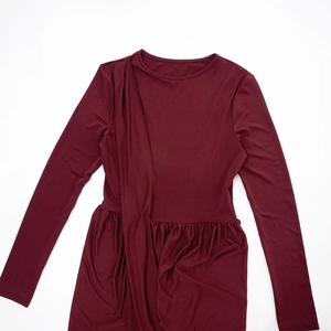 Detail view of wine red knitted long dress with waist ruching and elegant drape design